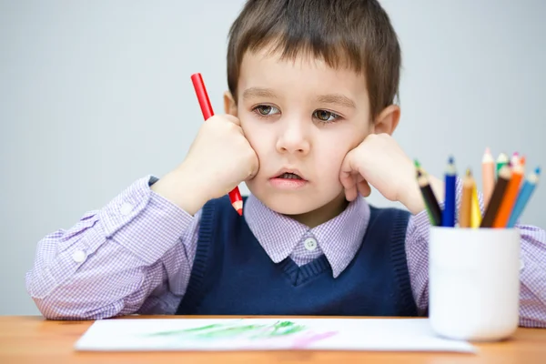 Little boy is holding color pencils Stock Photo