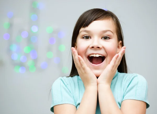 Girl is holding her face in astonishment — Stock Photo, Image