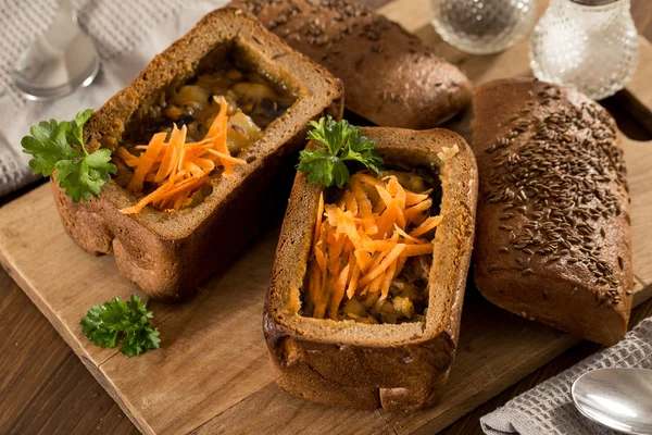 Fresh pea soup in bread bowl on a wooden desck — Stock Image Fresh pea soup in bread bowl on a wooden desck Stock Image