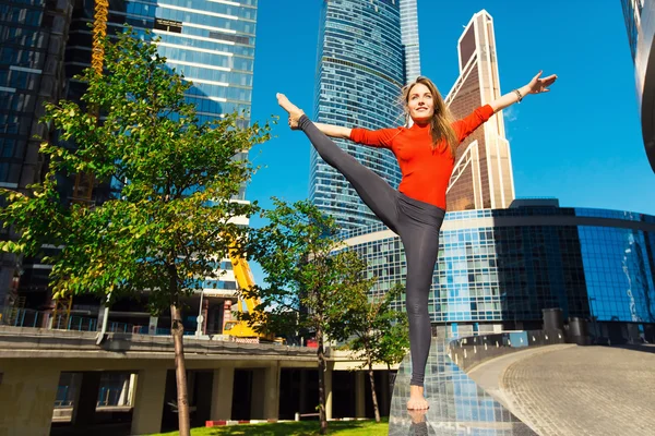 Genç kız açık havada şehirde yoga yaparken — Stok fotoğraf