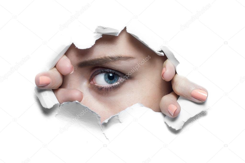 Woman Looking Through Ripped Paper Hole