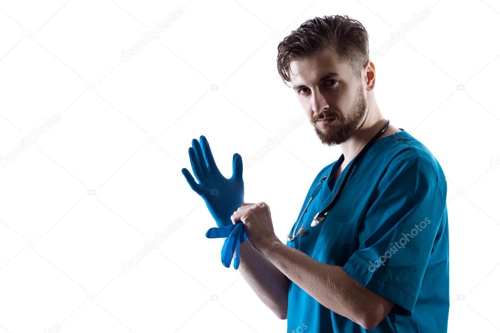 Man Doctor Surgeon Putting On Nitrile Gloves