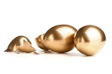 Kırık yumurta yakınındaki iki altın yumurta