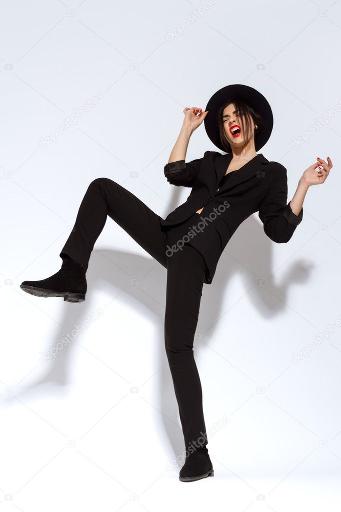 Handsome Fashion Woman With Hat In Black Suit