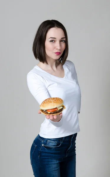 Girl eating healthy sandwich isolated on white background — Stockfoto