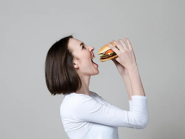 Girl eating healthy sandwich isolated on white background