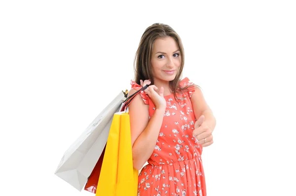 Mode vrouw portret geïsoleerd. witte achtergrond. gelukkig meisje wachtruimte shopping bag. rode jurk. vrouwelijke mooi model. — Stockfoto