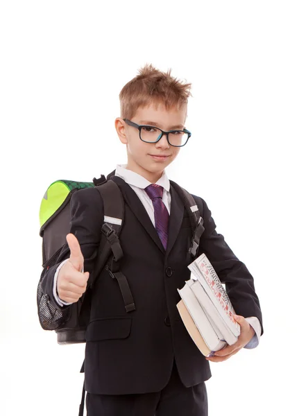 Colegial con una mochila, un montón de libros aislados sobre fondo blanco — Foto de Stock