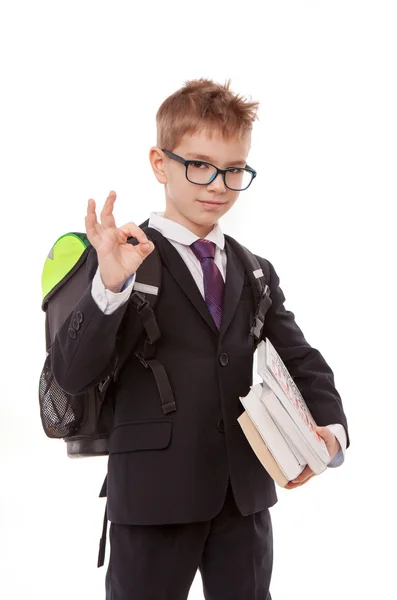 Colegial con una mochila, un montón de libros aislados sobre fondo blanco — Foto de Stock