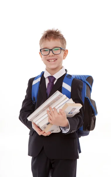 Colegial con una mochila, un montón de libros aislados sobre fondo blanco — Foto de Stock