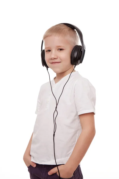 Boy in headphones, singing into a microphone on a white background Royalty Free Stock Photos