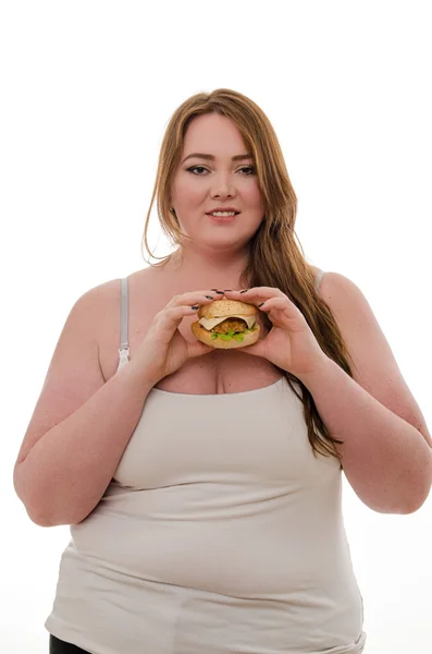 Жирна жінка їсть гамбургер ізольовано на білому тлі — стокове фото