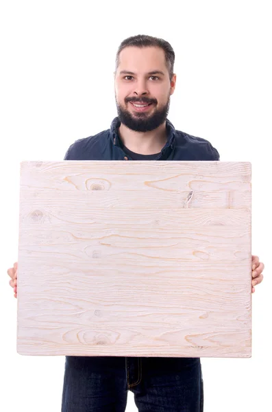 Giovane bel ragazzo con la barba con un vuoto di legno nelle mani isolato su sfondo bianco Immagine Stock