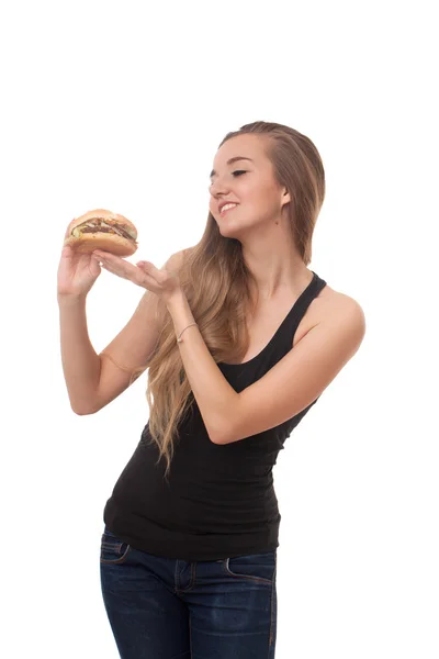 Joven hermosa chica con una hamburguesa en la mano aislado sobre fondo blanco — Foto de Stock