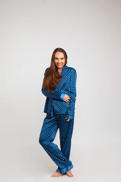 Ung vacker flicka i en blå pyjamas — Stockfoto