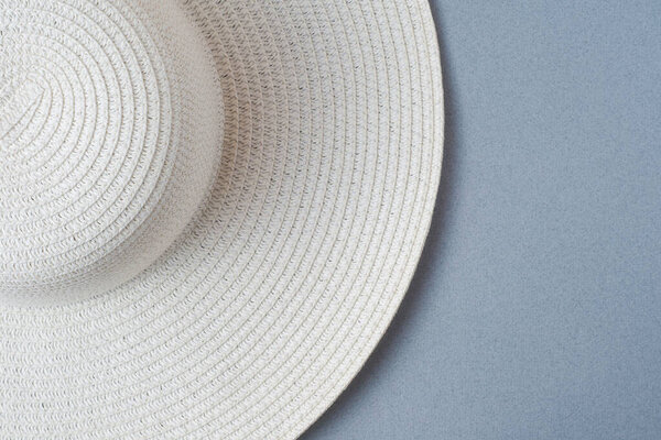 A large white beach lady's hat on a pastel beige background. The concept of vacation, vacation, travel, sales, black Friday.