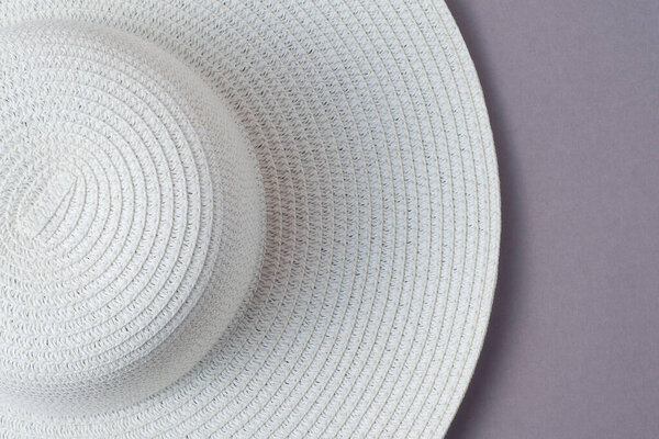 A large white beach lady's hat on a pastel beige background. The concept of vacation, vacation, travel, sales, black Friday.