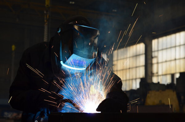 Welders working at the factory made metal