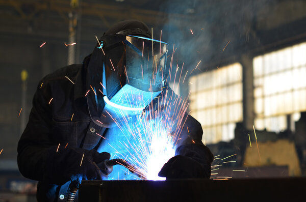Welders working at the factory made metal
