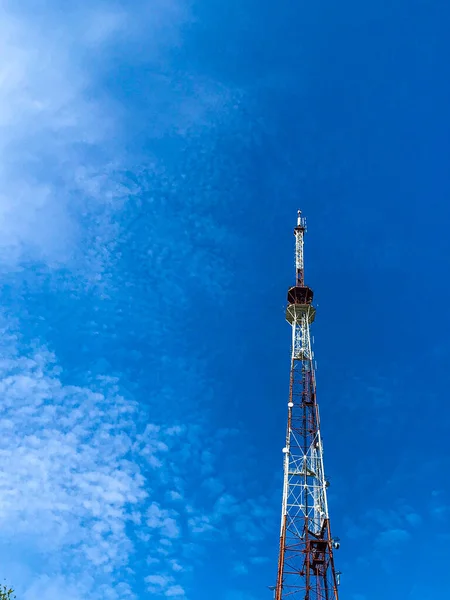 A TV-radio tower. against the blue sky. The radio tower. Tv tower