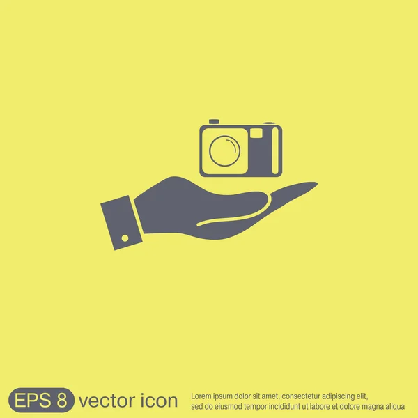 Hand met een fotocamera — Stockvector