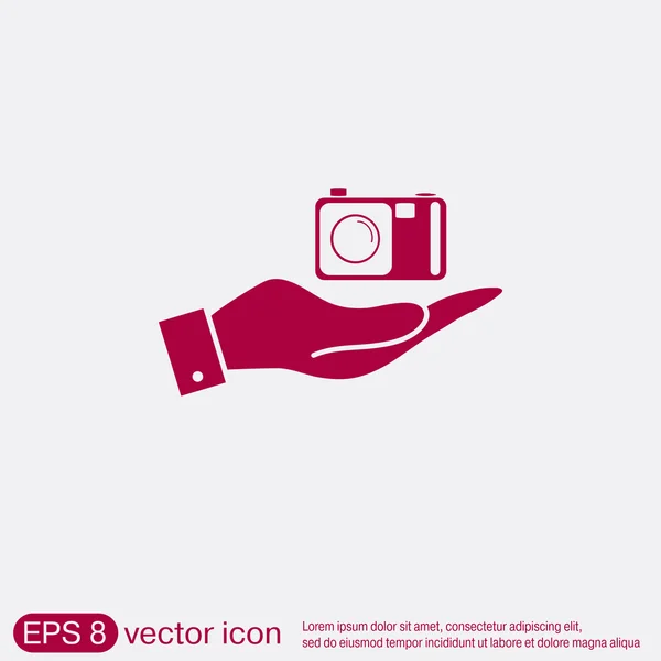 Hand holding a photo camera — Stock Vector