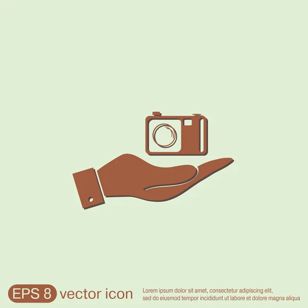 Hand holding a photo camera — Stock Vector