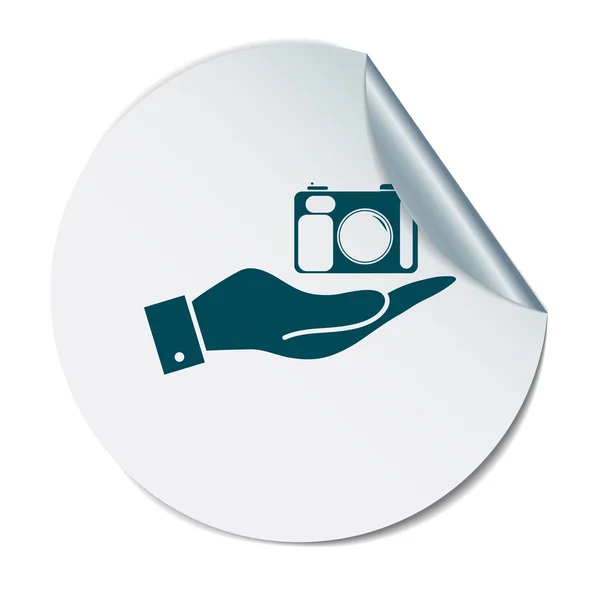 Mão segurando câmera de fotos — Vetor de Stock