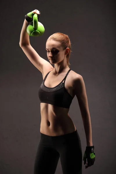 Sporty girl doing exercise with dumbbells in the gym Stock Photo by  ©fenixlive 92539366