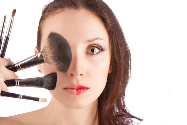 Hermosa mujer rubia antes y después del maquillaje con un cepillo de maquillaje sobre blanco —  Fotos de Stock