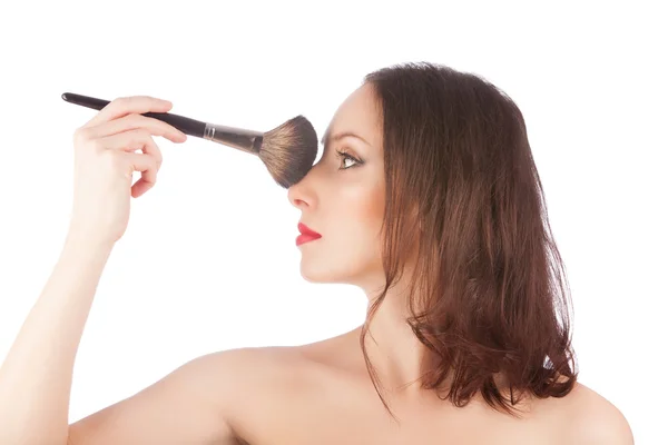 Hermosa mujer rubia antes y después del maquillaje con un cepillo de maquillaje sobre blanco —  Fotos de Stock