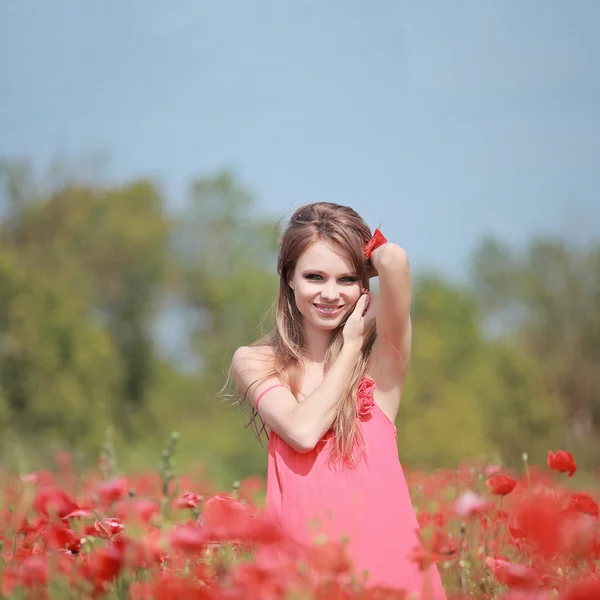 Красивая девушка в маковом поле, красное платье — стоковое фото