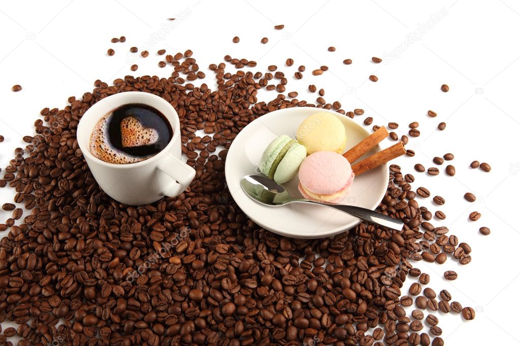 Coffee cup with macaroon and beans on a white background.