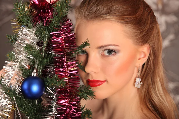 Schöne Frau schmückt den Weihnachtsbaum — Stockfoto