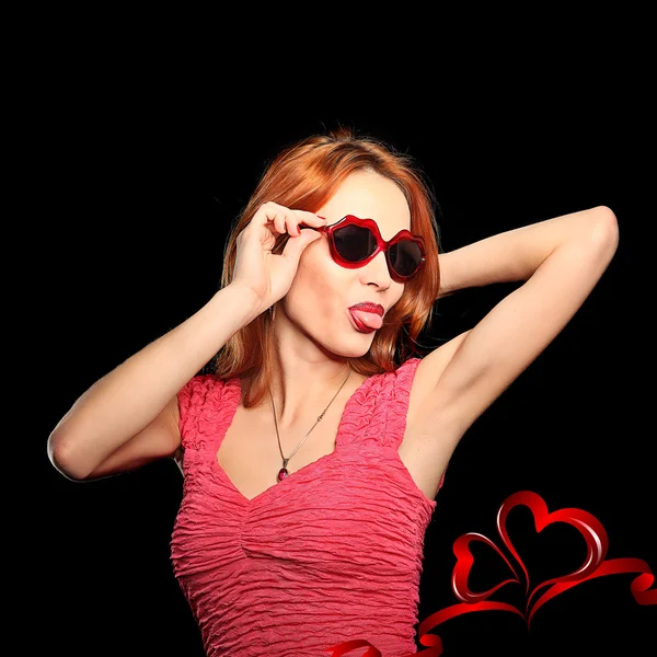 Girl with heart-shaped glasses and closed eyes smiling — Stock Photo, Image