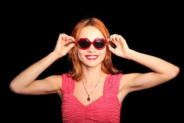 Girl with heart-shaped glasses and closed eyes smiling — Stock Photo, Image