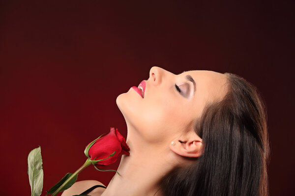 Valentines beautyfull girl with red rose in her hands, studio