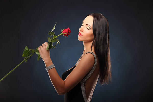 Valentines beautyfull girl with red rose in her hands, studio
