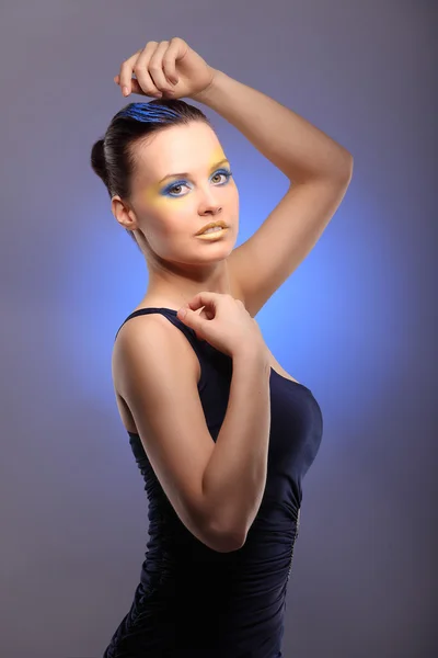 Beautiful young woman with blue creative make-up — Stock Photo, Image