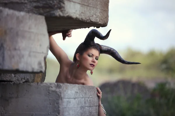 The beautiful young girl with horns like devil or angel — Stock Fotó