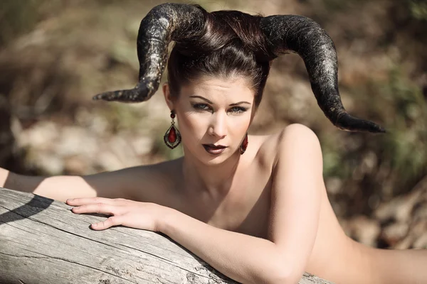 The beautiful young girl with horns like devil or angel — Stockfoto