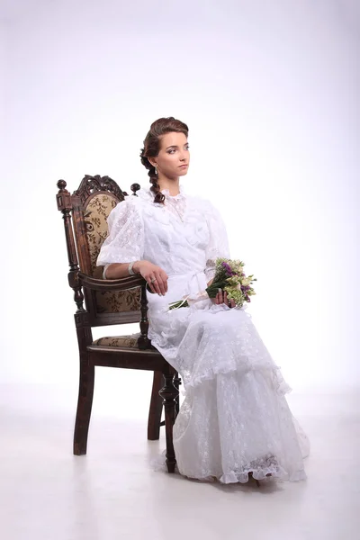 Portrait of young woman on vintage chair retro wedding — Stock Photo, Image