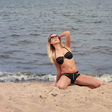 Güneşli sahilde bikinili güzel genç kadın