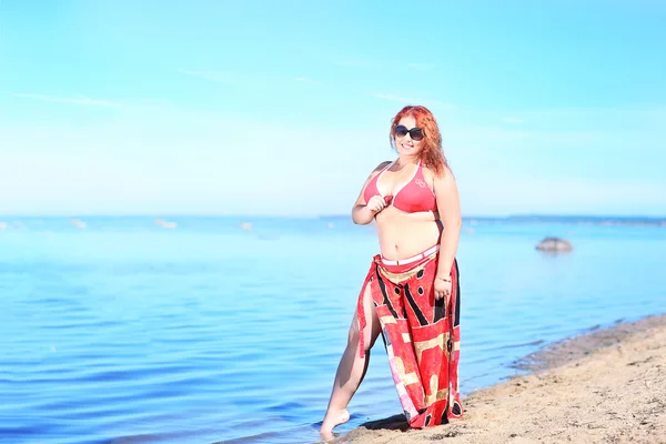 Red-haired plus size woman resting on coast — Stock Photo, Image