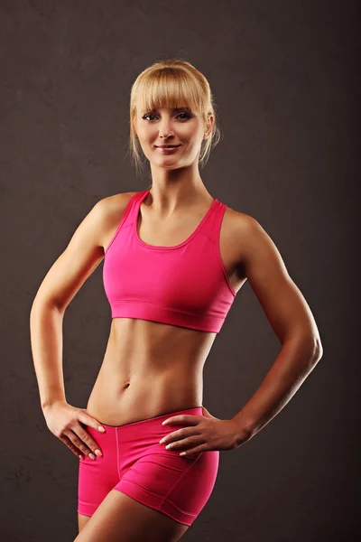 Fitness girl on a dark background — Stock Photo, Image