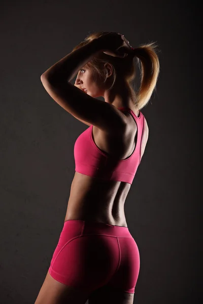 Fitness girl on a dark background — Stock Photo, Image