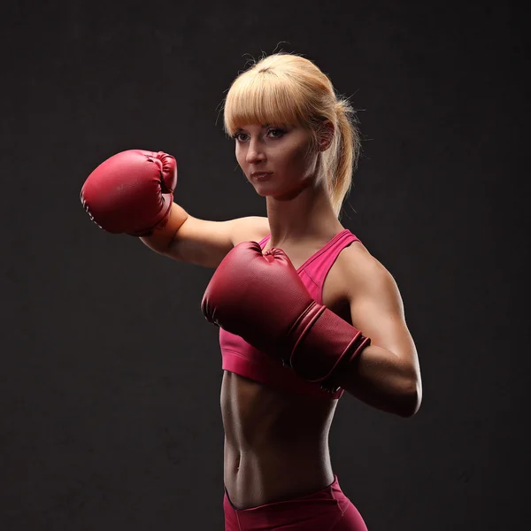 Young sexy girl over black background with boxing gloves — Stock Photo, Image