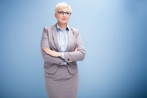 Blonde businesswoman on blue background. — Stock Photo, Image