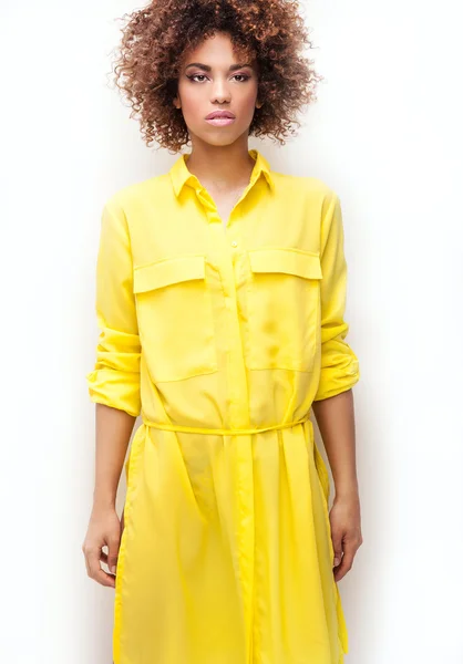 Girl with afro in yellow dress. — Stock Photo, Image