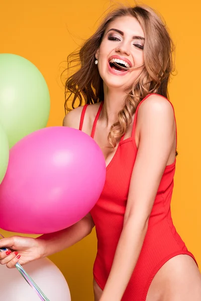 Girl with balloons posing in studio. — Stock Photo, Image